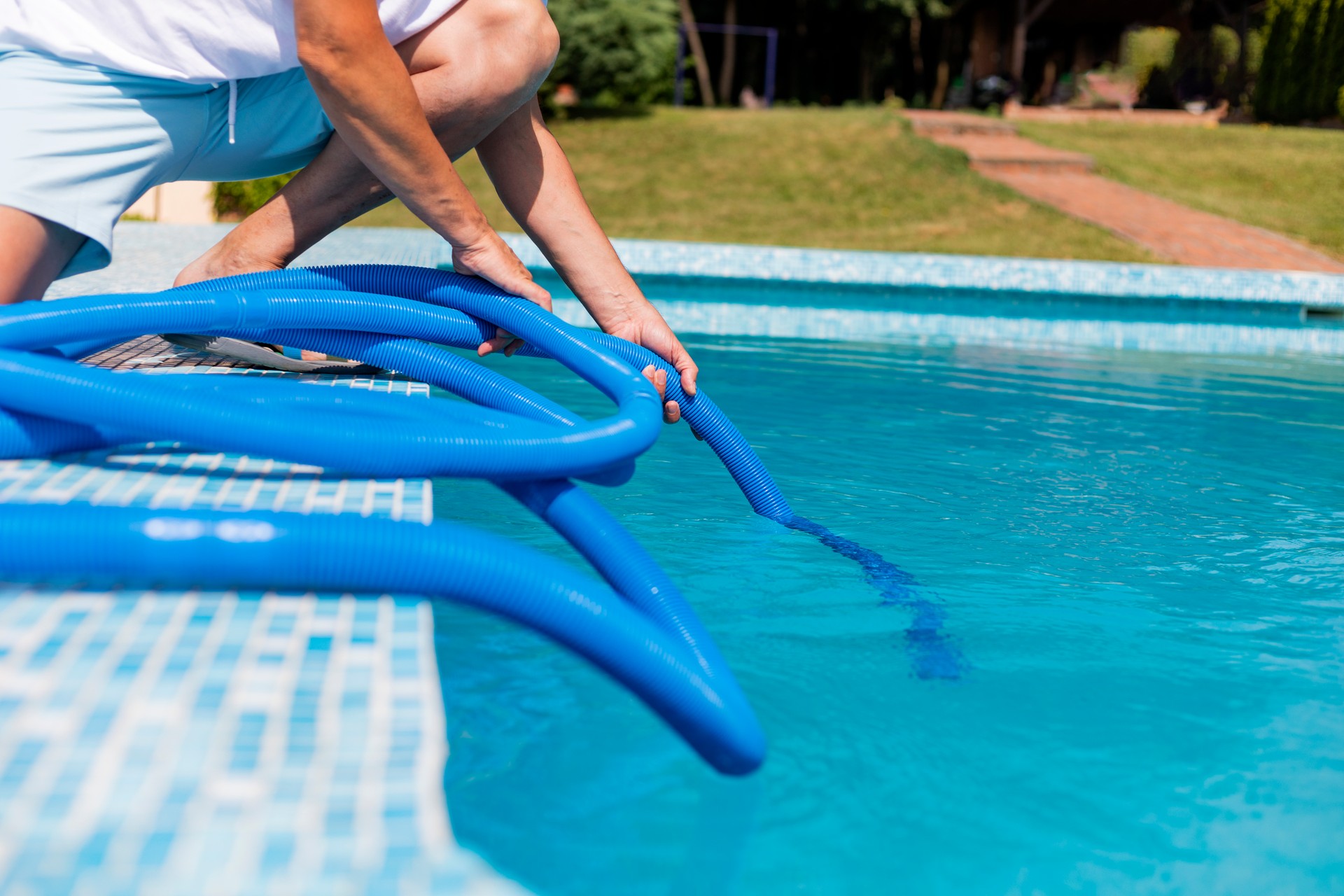 Man cleaning the swimming pool